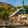 Edelweiss hut on Schneeberg with mountain scenery and forest in the background.
