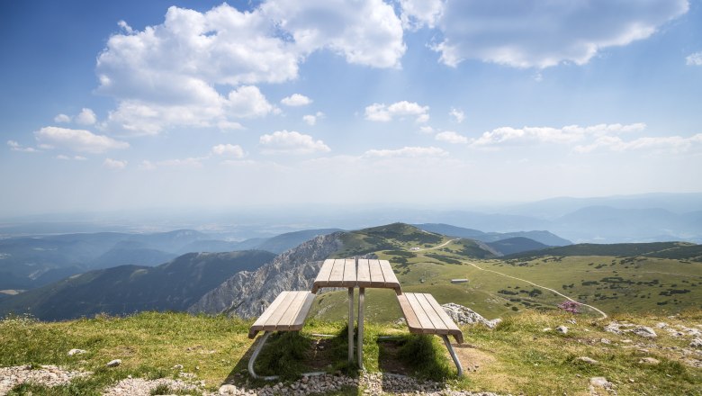 Picnic table on a mountain with a wide view over the landscape.