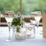 Elegant table decoration with champagne glasses, candles and napkins.