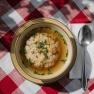 Klare Suppe mit Grie&szlig;nockerl in einem Teller auf karierter Tischdecke beim Damb&ouml;ckhaus am Schneeberg