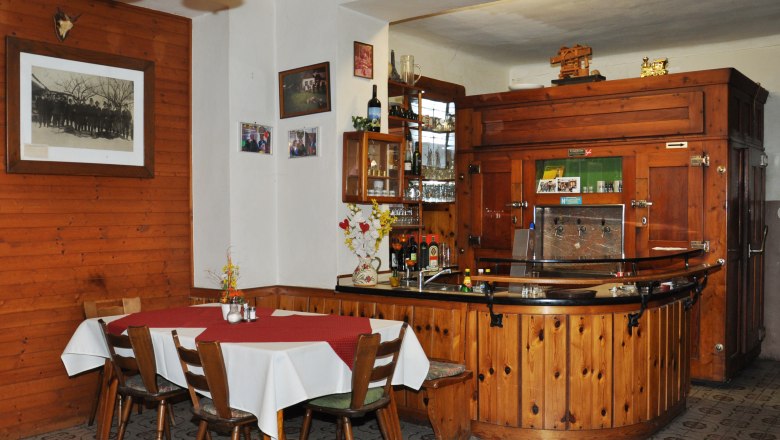 Interior view of a traditional inn with wooden furniture and bar.